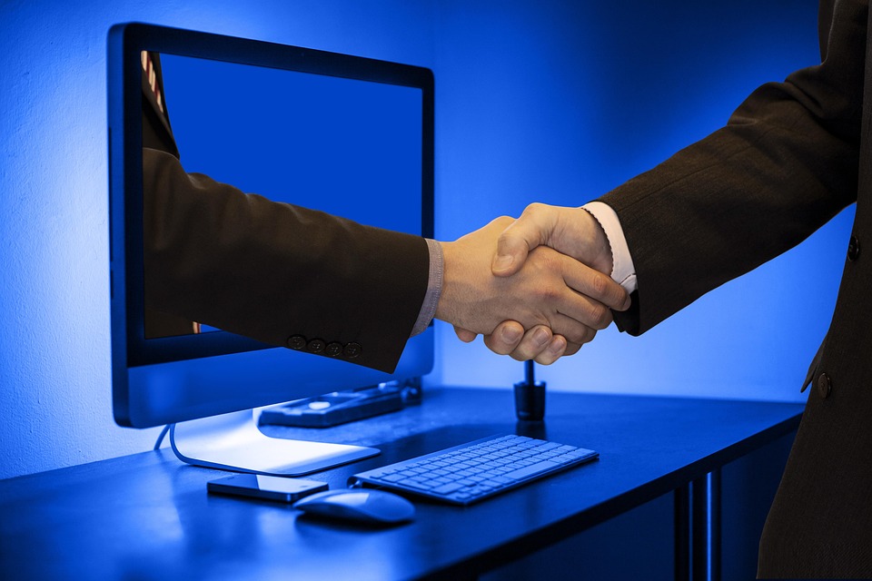 Two business hands shaking, symbolizing a partnership.
